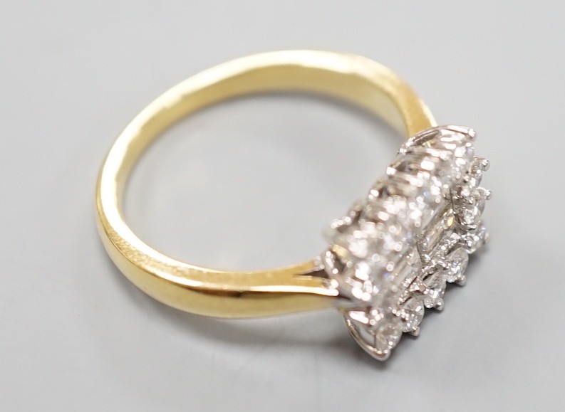 A 750 yellow metal, baguette and round cut diamond set rectangular cluster ring, size M, gross weight 4.8 grams.